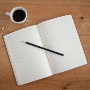 blank calendar page with coffee cup and pencil